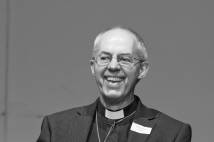 Justin Welby laughing on stage in Bristol