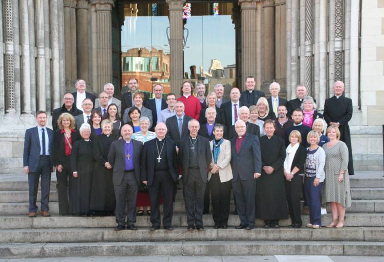 Archbishop Justin and Caroline Welby with clergy on the steps of St Anne's Cathedral.
