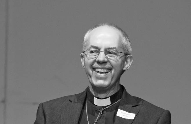 Justin Welby laughing on stage in Bristol