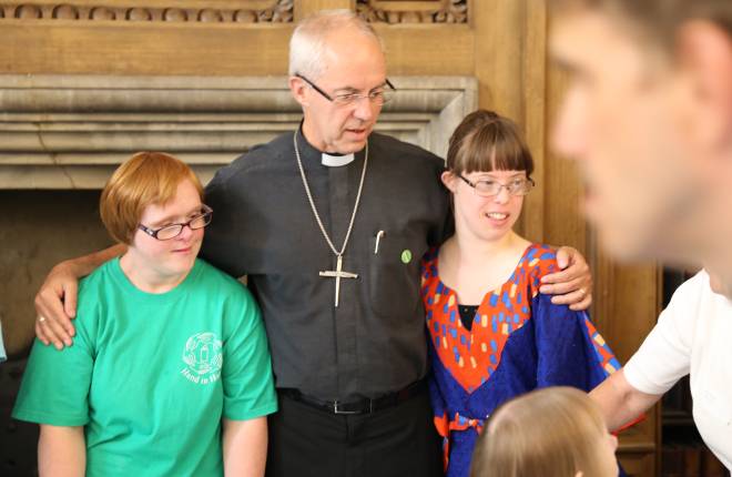 Justin Welby with two members of Hand in Hand worship group 
