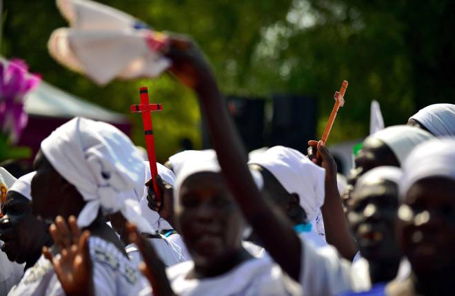 Women holding crosses in Uganda 